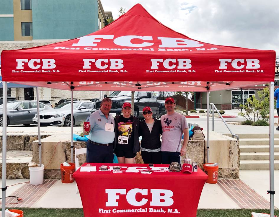 A shade tent with FCB employees under it.