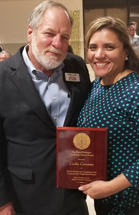 Mark and Cecilia posing with her award